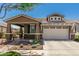 Charming single-Gathering home with a two-car garage, desert landscaping, and a covered front porch at 4898 N 206Th Ln, Buckeye, AZ 85396