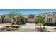Charming single-story home with well-manicured landscaping, a covered porch, and a two-car garage in a peaceful neighborhood at 4898 N 206Th Ln, Buckeye, AZ 85396