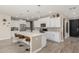 Well-designed kitchen with an island, stainless steel appliances, and modern lighting fixtures at 4898 N 206Th Ln, Buckeye, AZ 85396
