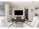 Cozy living room featuring a sleek TV, comfortable seating, and modern decor at 4898 N 206Th Ln, Buckeye, AZ 85396