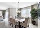 Bright dining area showcasing table, chairs, chandelier, and large window with a backyard view at 4999 E Umber Rd, San Tan Valley, AZ 85143