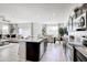Spacious open-concept kitchen with stainless steel appliances and granite countertops flows into dining and living areas at 4999 E Umber Rd, San Tan Valley, AZ 85143
