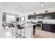 Modern kitchen featuring dark cabinetry, granite countertops, and stainless steel appliances at 4999 E Umber Rd, San Tan Valley, AZ 85143