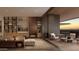 Open living room with sleek built-ins, fireplace, and seamless access to a private terrace and desert sunset view at 5050 N Camelback Ridge Dr # 2101, Scottsdale, AZ 85251