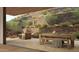 Secluded patio with natural stone landscape and desert foliage providing a private outdoor dining and seating area at 5050 N Camelback Ridge Dr # 2101, Scottsdale, AZ 85251