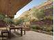 Desert view patio with dining and lounge seating surrounded by lush foliage and stone accents, perfect for relaxation at 5050 N Camelback Ridge Dr # 2101, Scottsdale, AZ 85251