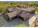 Expansive aerial view of an estate highlighting its multiple garages, tile roof, and desert surroundings at 5712 E Blue Sky Dr, Scottsdale, AZ 85266
