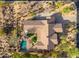 Aerial view of an estate with a manicured lawn, a pool, patio, and landscaping at 5712 E Blue Sky Dr, Scottsdale, AZ 85266