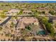 An estate from above showing the backyard with a pool and well landscaped desert plants at 5712 E Blue Sky Dr, Scottsdale, AZ 85266