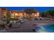 Beautiful backyard featuring a pool, outdoor seating, lush lawn, and desert landscaping at 5712 E Blue Sky Dr, Scottsdale, AZ 85266