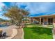 Resort-style backyard with lush landscaping, comfortable seating, pool, and outdoor living spaces at 5712 E Blue Sky Dr, Scottsdale, AZ 85266