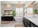 Luxurious bathroom featuring dual vanities, soaking tub, and a stylish pendant light at 5712 E Blue Sky Dr, Scottsdale, AZ 85266