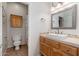 Bathroom with warm wooden vanity and shower with decorative tiles at 5712 E Blue Sky Dr, Scottsdale, AZ 85266