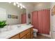 Bathroom with a single sink, shower with a pink curtain, and decorative details at 5712 E Blue Sky Dr, Scottsdale, AZ 85266