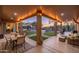 Relaxing covered patio with an outdoor dining area and views of lush landscaping at 5712 E Blue Sky Dr, Scottsdale, AZ 85266
