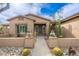 Inviting home exterior showcasing a well-maintained front yard, decorative pottery, and a quaint walkway at 5712 E Blue Sky Dr, Scottsdale, AZ 85266