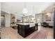 Open concept kitchen with a large island, farmhouse sink, and views of the living area at 5712 E Blue Sky Dr, Scottsdale, AZ 85266