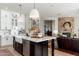 Modern kitchen with an island, white cabinetry, stainless appliances, and an open layout to the living area at 5712 E Blue Sky Dr, Scottsdale, AZ 85266