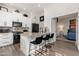 Stylish kitchen island featuring granite countertops, bar seating and open view to the bedroom at 5712 E Blue Sky Dr, Scottsdale, AZ 85266