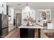 Modern kitchen featuring a center island with seating, stainless steel appliances, and ample cabinet space at 5712 E Blue Sky Dr, Scottsdale, AZ 85266