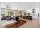 Open-concept living room with modern kitchen, a large sofa, and bright, natural light at 5712 E Blue Sky Dr, Scottsdale, AZ 85266