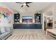 Spacious living room with custom built-in shelving, and a vibrant world map feature wall at 5712 E Blue Sky Dr, Scottsdale, AZ 85266