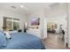 Spacious main bedroom with lots of natural light, television, and access to the living room at 5712 E Blue Sky Dr, Scottsdale, AZ 85266