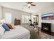 Relaxing main bedroom featuring a fireplace, comfortable seating, and backyard access at 5712 E Blue Sky Dr, Scottsdale, AZ 85266