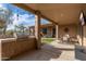 Spacious covered patio featuring a built-in outdoor kitchen and comfortable seating area at 5712 E Blue Sky Dr, Scottsdale, AZ 85266
