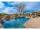 Inviting swimming pool and spa with lush landscaping and mature trees with desert landscape views at 5712 E Blue Sky Dr, Scottsdale, AZ 85266
