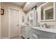 Well-lit bathroom featuring double sinks, white cabinets, and modern finishes at 6532 E Aster Dr, Scottsdale, AZ 85254