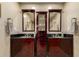 Bathroom featuring double sinks, dark vanities, and modern fixtures at 6532 E Aster Dr, Scottsdale, AZ 85254