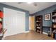 A bedroom with light wood floors, a large closet, and a dark blue accent wall at 6532 E Aster Dr, Scottsdale, AZ 85254
