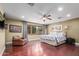 A spacious bedroom with a large window and hardwood floors throughout at 6532 E Aster Dr, Scottsdale, AZ 85254