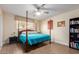 Comfortable bedroom with natural light, a ceiling fan and hardwood floors at 6532 E Aster Dr, Scottsdale, AZ 85254