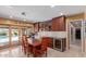 Cozy breakfast nook with wine refrigerator, kitchen access, and sliding glass doors leading to the pool at 6532 E Aster Dr, Scottsdale, AZ 85254