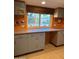 Kitchen with light blue cabinets, an orange backsplash, and a view of the backyard pool at 6532 E Aster Dr, Scottsdale, AZ 85254