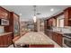 Kitchen island featuring granite countertops, seating, and stainless steel appliances at 6532 E Aster Dr, Scottsdale, AZ 85254