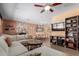 Open-concept living room with stone fireplace, built-in shelving, and seamless flow to the dining area at 6532 E Aster Dr, Scottsdale, AZ 85254