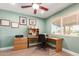 A well-lit home office featuring a corner desk, light green walls, and a ceiling fan at 6532 E Aster Dr, Scottsdale, AZ 85254
