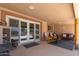 Relaxing covered patio with comfortable seating and view of the pool through glass doors at 6532 E Aster Dr, Scottsdale, AZ 85254