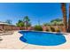 Beautiful private pool with lush landscaping, tanning deck, and clear blue water at 6532 E Aster Dr, Scottsdale, AZ 85254