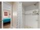 Tiled shower with a glass door, with a view of the bedroom, and neutral colors at 6532 E Aster Dr, Scottsdale, AZ 85254