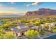 Beautiful aerial view of a desert home with stunning architecture and mountain views in the background at 6551 E Flat Iron Loop, Gold Canyon, AZ 85118