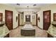 Luxurious bathroom featuring a large tub with a mosaic tile surround and two doors to separate vanities at 6551 E Flat Iron Loop, Gold Canyon, AZ 85118
