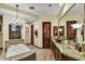 Bathroom featuring granite counters, wooden cabinets, a soaking tub and tiled shower at 6551 E Flat Iron Loop, Gold Canyon, AZ 85118