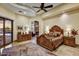 Primary bedroom featuring a king-sized bed, access to the pool, and a cozy sitting area at 6551 E Flat Iron Loop, Gold Canyon, AZ 85118