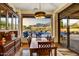 Dining area with view of pool, with built-in cabinets, modern lighting, and sliding glass doors to patio at 6551 E Flat Iron Loop, Gold Canyon, AZ 85118