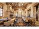 Stunning dining area with stone walls, fireplace and elegant seating creates an intimate ambiance at 6551 E Flat Iron Loop, Gold Canyon, AZ 85118