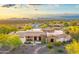 Desert home showcasing a welcoming entrance, gorgeous stone details, solar panels, and drought-tolerant landscaping at 6551 E Flat Iron Loop, Gold Canyon, AZ 85118